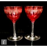 A pair of early 20th Century Stourbridge cranberry wine glasses, circa 1900, the ovoid bowl
