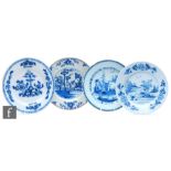 Four 19th Century tin glazed plates of varying form each decorated in blue and white with