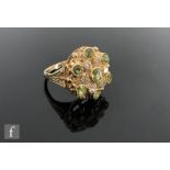 A 9ct hallmarked peridot and diamond cluster ring, circular pierced head detailed with seven