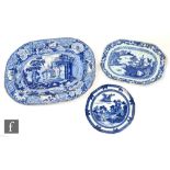 A large 19th Century blue and white meat plate transfer decorated with ruins in a landscape with a