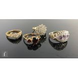 Three 9ct rings to include a cubic zirconia cluster, diamond cluster and a garnet three stone, total