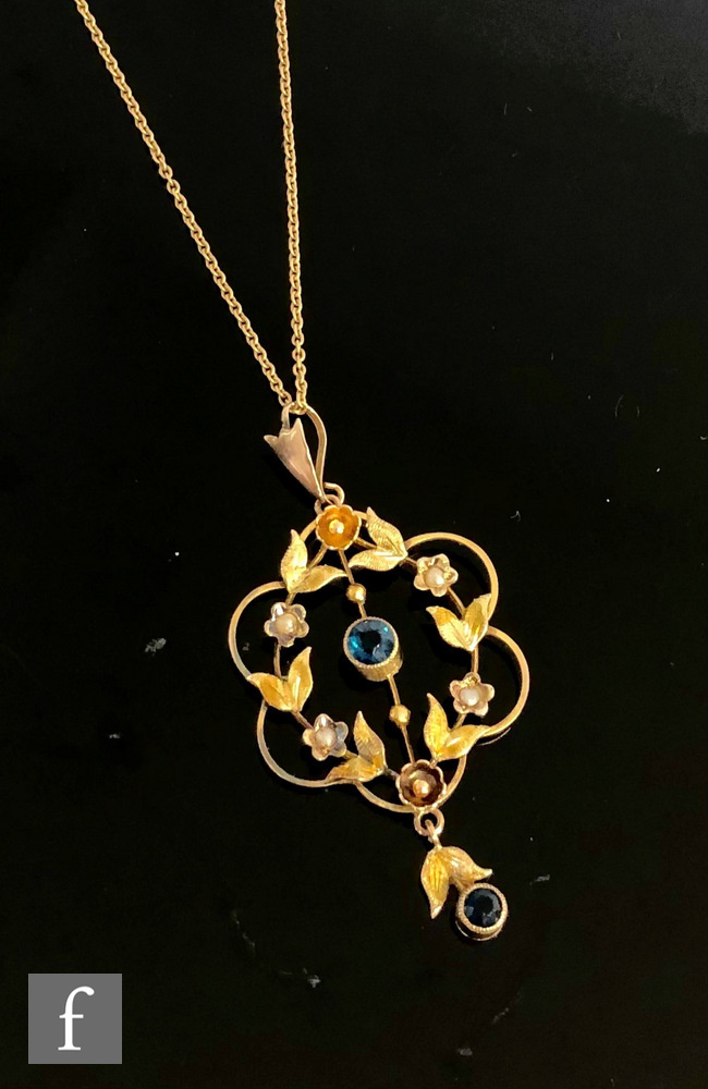 An Edwardian 9ct open work pendant set with seed pearl and blue zircon stones with matt finished