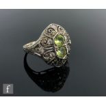A 9ct hallmarked Edwardian style peridot and diamond cluster ring, two central peridot to a white
