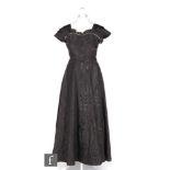 A 1940s/50s ladies vintage evening dress in black silk taffeta, with cap sleeves, ruffle