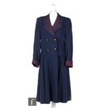 A 1940s ladies vintage Alfred Ironmonger coat, single breasted in blue with dark purple