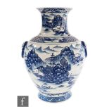 A large Chinese blue and white vase of baluster form, rising from a splayed footrim, the body