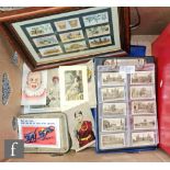 A collection of various cigarette cards contained in vinyl albums, loose postcards and stamp PQ