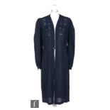 A 1930s ladies vintage crepe overcoat in navy blue with pierced detailing to the front fastening