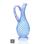 A 20th Century crystal glass jug of footed baluster form with drawn collar rim and high loop handle,