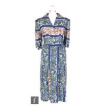 A 1940s CC41 Utility ladies vintage dress in blue with bands of floral patterns in red, blue,