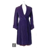 A 1920s ladies vintage opera coat in Cadbury purple velvet with a sailor collar and double fastening