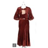 A late 1920s/30s ladies vintage dress in dark red velvet, with bow and blush ruffles detailing to
