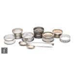 Seven hallmarked silver Victorian and later napkin rings with two silver spoons, total weight 4.3oz,