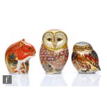 Three Royal Crown Derby paperweights comprising two owls and a squirrel, all with printed marks