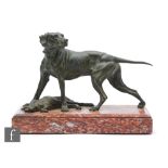 A 20th Century green painted spelter study, modelled as a pointer standing over a hare, mounted to a
