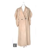 A 1910s/1920s ladies vintage dress coat in fawn silk with leg of mutton sleeves, the front with