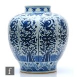 A large Chinese blue and white vase of rounded ovoid form, rising from a spreading circular