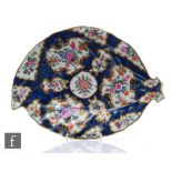A late 18th Century Worcester blue scale ground leaf shaped dish with hand painted floral
