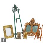 A Victorian French rococo double photo frame with figural mask and cherubs, height 36cm, a brass