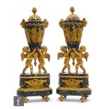 A pair of late 19th Century French ormolu mounted variegated marble urns, detailed with cherubs