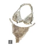 A vintage Eastern white metal belly dancing bralet and hip belt, both with chain mail floral