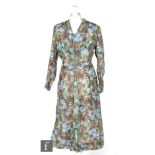 A 1950s ladies vintage dress with a printed blue, green and brown floral pattern, with tapered