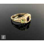 A 9ct hallmarked Edwardian style amethyst, peridot and seed pearl seven stone boat shaped ring,