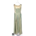 A 1920s full length evening dress in an aqua with a gold wavy line, approximate size 16. S/D