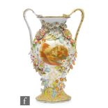 A late 19th Century vase of baluster form with high arched handles, decorated with a cartouche panel