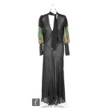 A 1920s/30s ladies vintage evening dress in sheer black crepe, with balloon sleeves, with green