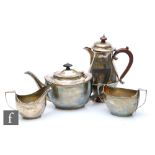 A hallmarked silver three piece boat shaped tea set of plain form with egg and dart detail to