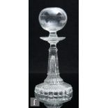 A 19th Century glass lace maker's lamp with a wide circular spread pressed glass foot rising to a