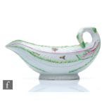 An 18th Century Worcester Cos Lettuce shape sauce boat, the moulded body sparsely decorated with