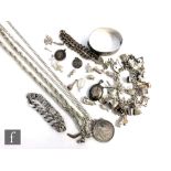 A small parcel lot of assorted silver jewellery to include a bangle, curb and charm bracelets, loose