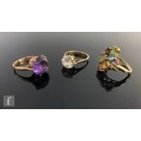 Three 9ct stone set rings to include a white paste solitaire and multi stone cluster example,