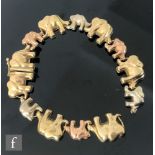 A three coloured 9ct hallmarked bracelet modelled as a line of elephants, weight 13.5g,