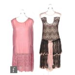 A 1920s ladies vintage dress in pink chiffon with black lace overlay, drop waist with two tier