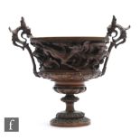 A bronze two handled chalice in the manner of Barbedienne, mounted with two winged dragons above a