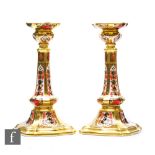 A pair of Royal Crown Derby candlesticks decorated in an Imari pattern, exclusively commissioned