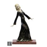 A 20th Century Art Deco painted spelter study, depicting a female figure in evening dress with