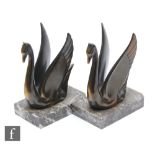 A pair of 20th Century French spelter bookends, decorated with bronzed stylised swans, mounted to