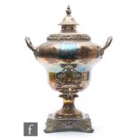 A late Victorian silver plated samovar, the square section plinth base raised on scrolling