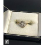 An 18ct diamond cluster ring, off set square head to knife edged shoulders, weight 3.5g, ring size