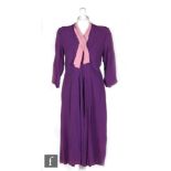 A 1930s/40s ladies vintage dress in purple crepe, with v neck and pink tie details, three quarter