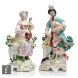 A pair of 19th Century Derby figures of musicians, she modelled playing the lute with a lamb to