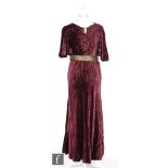 A 1920s/30s ladies vintage evening dress in deep purple velvet, with high neck and diamante clip