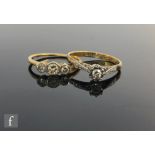 Two 18ct and platinum diamond set rings, a millgrain set three stone and an illusion set