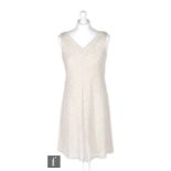 A 1960s ladies vintage mini dress with diagonal silver thread over off-white sparkle lurex with v