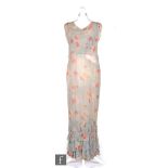 A 1930s ladies vintage dress in light blue chiffon, with pink rose bud printed pattern, with ivory