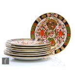 Eight assorted early 20th Century Derby cabinet plates of varying form each decorated in an Imari